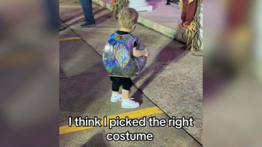 A toddler wearing a disco ball costume.