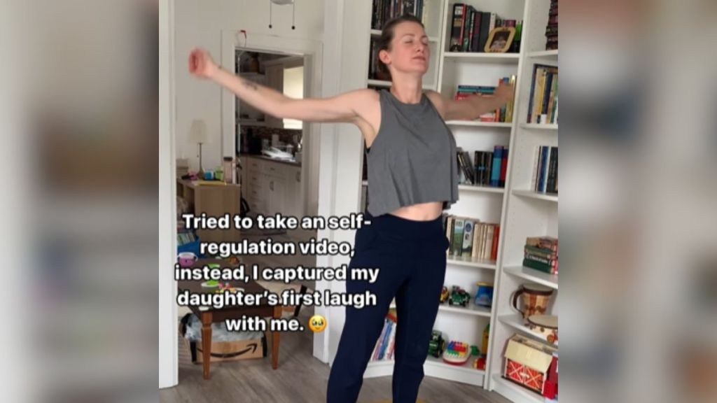 A woman in activewear doing an exercise in her home.