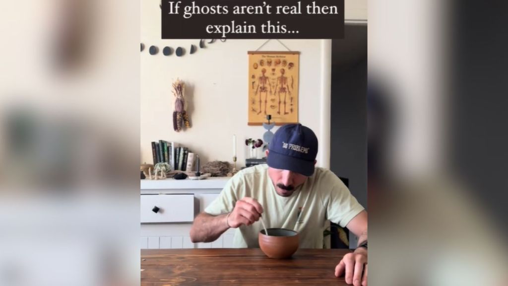 A man eating cereal at the table.