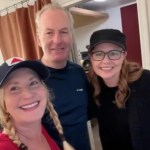 Jenna Fischer and Angela Kinsey smile as they pose with a man who is also smiling