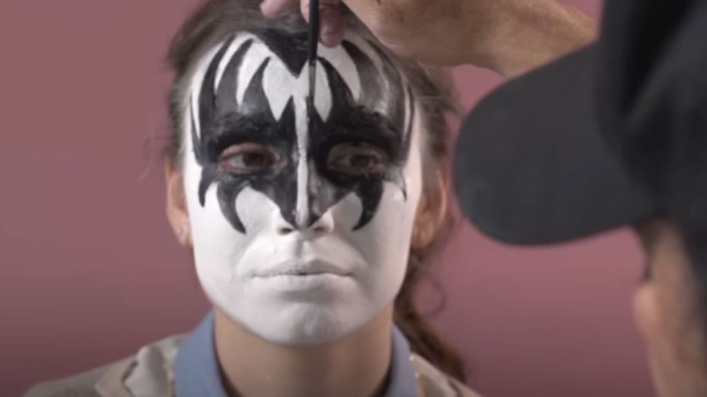 Image shows Gene Simmons applying his stage makeup on his daughter.