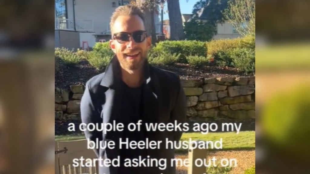 A man stands outside, hands behind his back, as he talks. Text on the image reads: a couple of weeks ago my blue heeler husband started asking me out on...