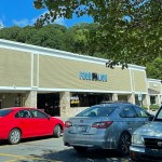 Exterior view of a Food Lion grocery store, as seen from the parking lot. There are a number of vehicles parked nearby