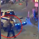 Street camera footage of downtown Orlando. People scatter in the distance as a cop tries to take down a shooter. The image is edited so there is a red circle indicating the location of the shooter and cop