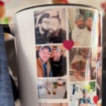 Close up of a mug being held by someone. The mug has various images of two men. The mug has red hearts throughout.