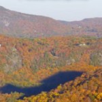 View of mountains in North Carolina as the sun slowly starts to set, a shadow forming in the distance