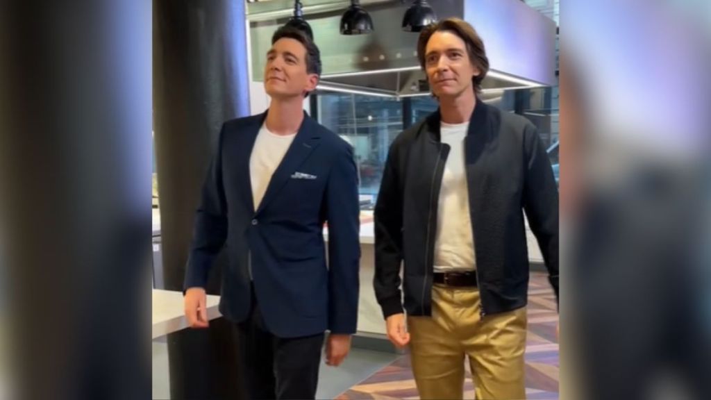 James and Oliver Phelps walking side by side.