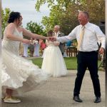 A dad dancing with his daughter at her wedding.