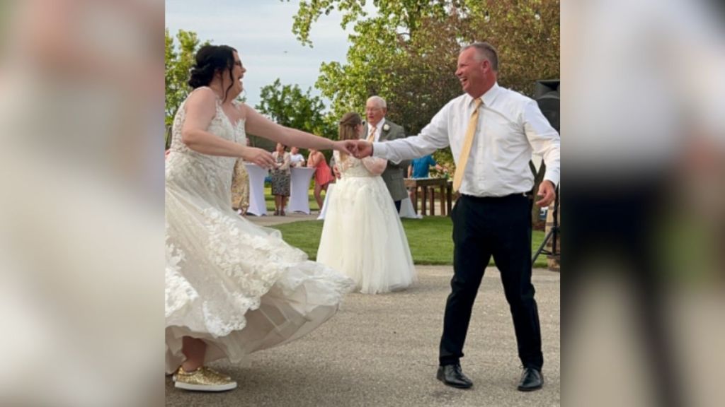 A dad dancing with his daughter at her wedding.