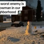 Image shows a snowman that a friendly dog always barks at.