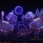 Image shows a gingerbread village displayed in the sky using drones.