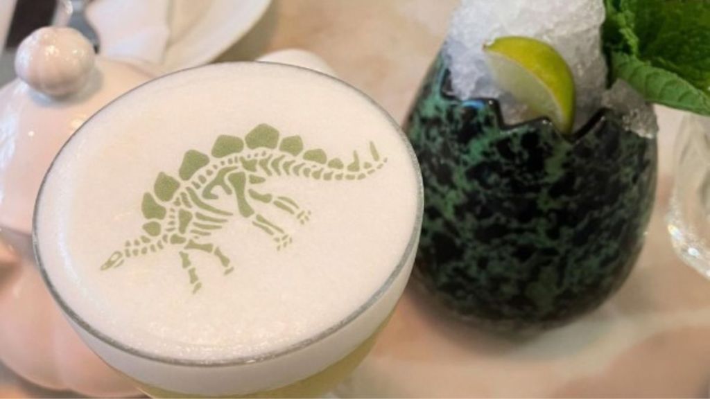 Image shows two of the specialty cocktails offered at the Jurassic-themed afternoon tea in a London hotel.