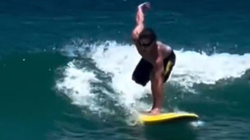 Image shows professional surfer Kai McKenzie returning to the waves after losing his right leg to a shark.