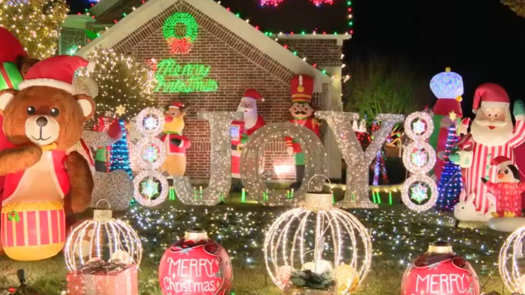 Exterior of home that is covered in lights and other various Christmas decor