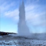 View from a distance of a frozen geyser erupting in Iceland