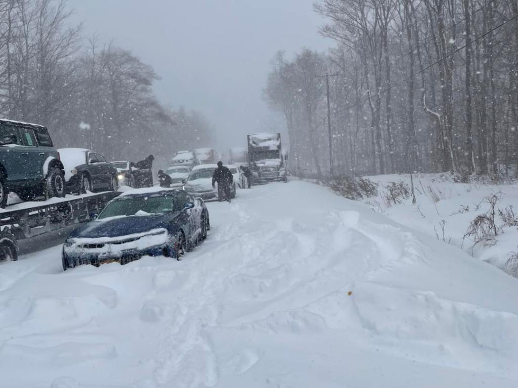 Cars and trucks stranded on the road in severe winter weather. 