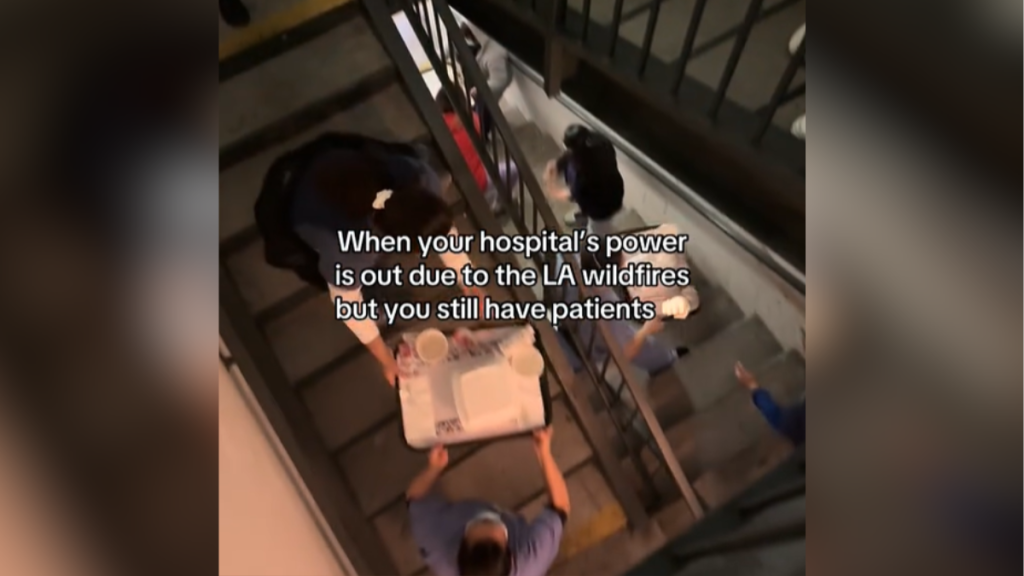 View of a line of healthcare workers on a staircase. They are passing along trays of food