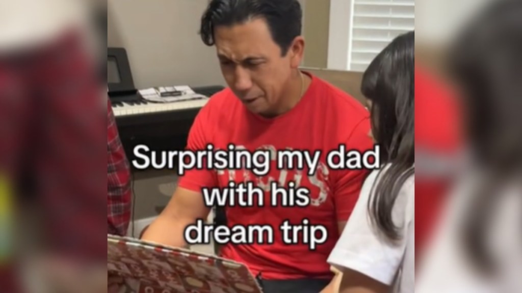 a dad looking down at a gift in awe with the caption "surprising my dad with his dream trip"