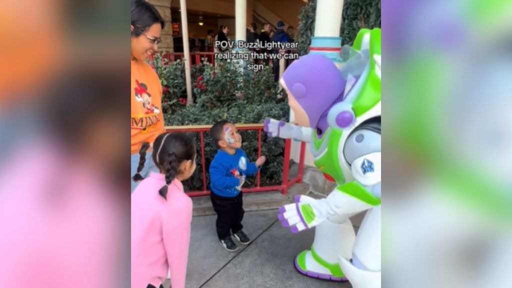 An actor in a Buzz Lightyear costume meets a little boy, his mom, and his older sister.