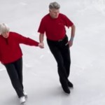 An elderly woman and man hold hands as they skate together on ice