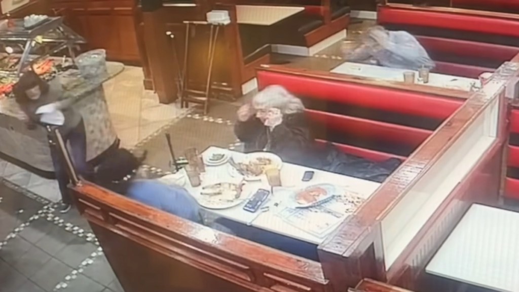 Security camera footage inside Four Seasons Diner in Philadelphia. Patrons at tables look distraught