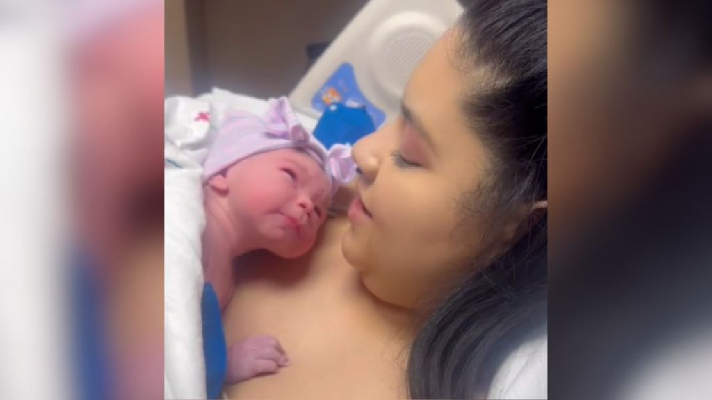 A mom holding her newborn baby at the hospital.