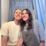 A couple smiling in a photo booth.