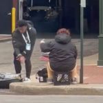 Image show NFL QB Malik Willis offering clothes to a homeless woman.