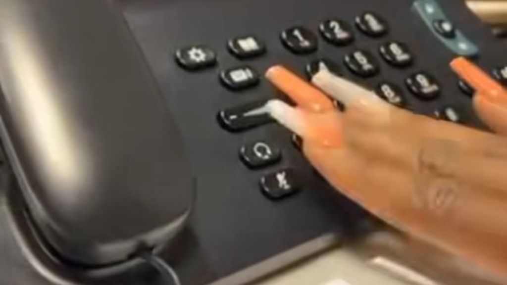 Image shows a desk phone as a customer listens to a patient's voicemail.