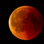 Close up of the Moon during a total lunar eclipse. This gives the Moon a reddish/orange color