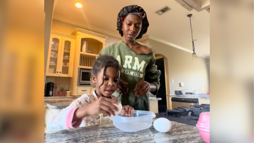 Mom patiently teaching her daughter to make egg snacks.