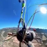 Close view of a skydiver as he tries to untangle his parachute while falling from the sky